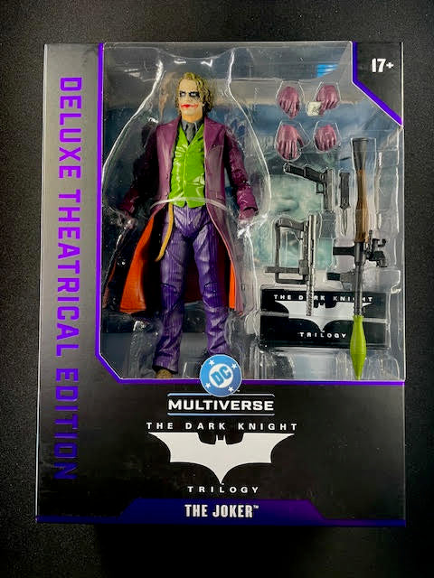 Deluxe Theatrical Edition Joker action figure in packaging with DC Multiverse branding.