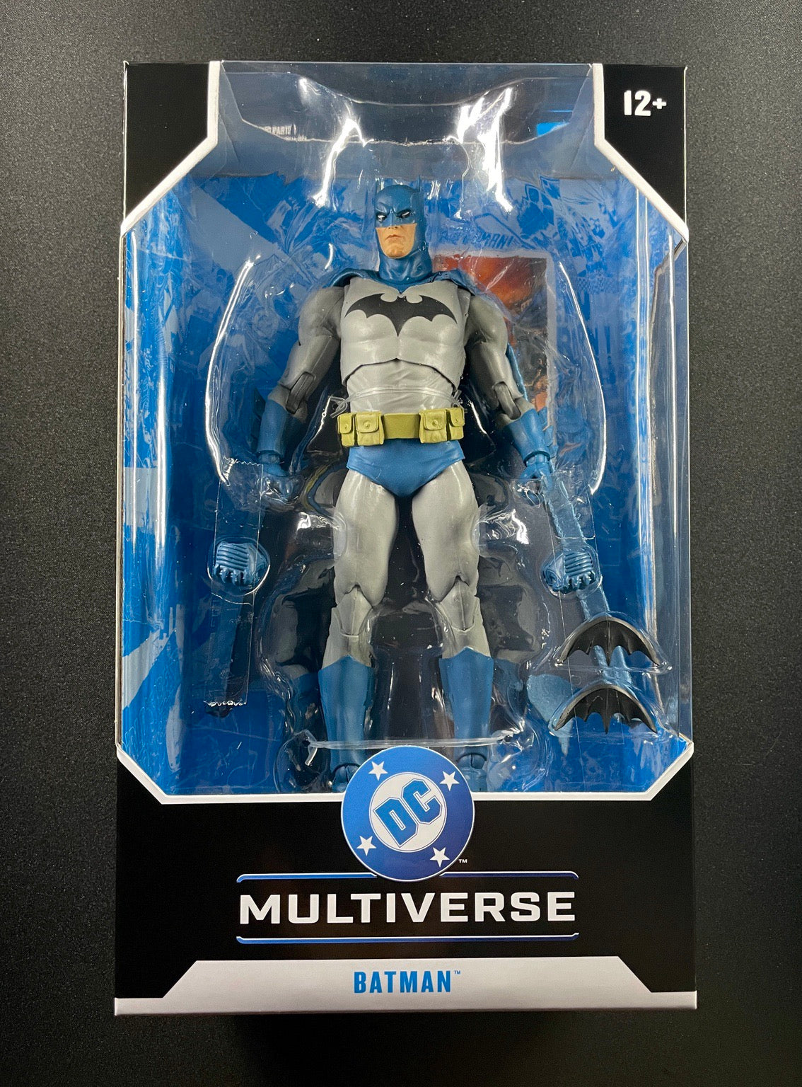 Batman action figure in packaging with DC Multiverse logo on a black background