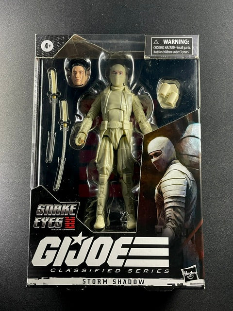 G.I. Joe Classified Series Storm Shadow Snake Eyes Origins movie action figure with white ninja armor, swords, and alternate head