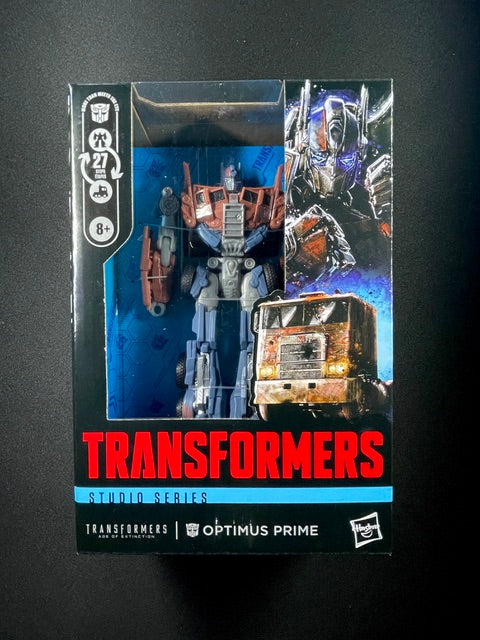 Transformers Studio Series Optimus Prime action figure from Age of Extinction converting from robot to weathered semi-truck in 27 steps
